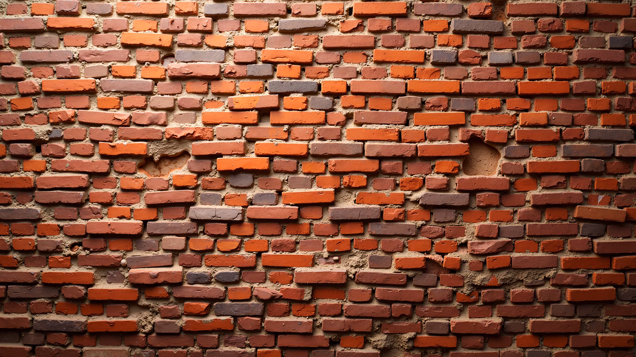 A close-up of a brick wall with varied colors and textures, perfect for architectural backgrounds.