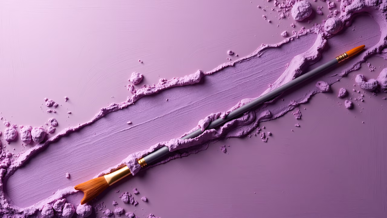 Two paintbrushes on a vibrant purple surface with scattered paint chunks, art supplies illustration.