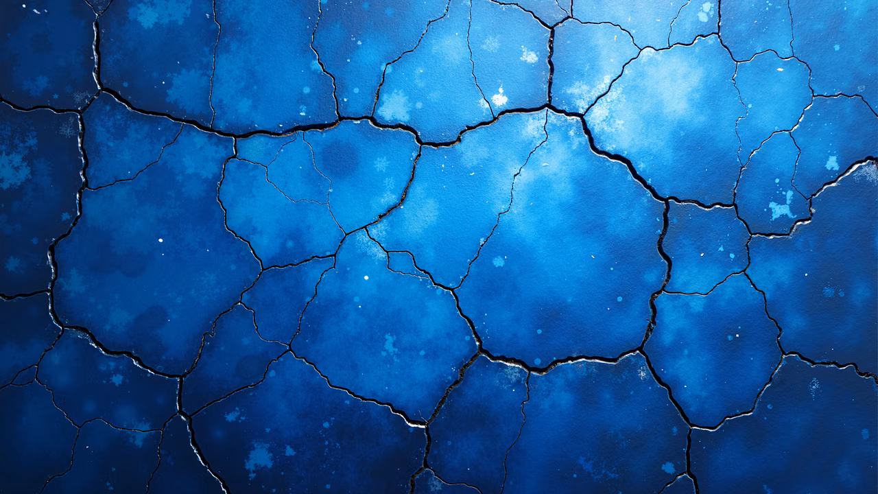 Abstract illustration of cracked earth in blue tones, emphasizing texture and depth.