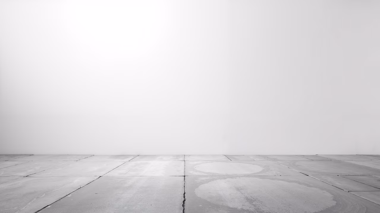 A minimalist illustration of an empty concrete floor under a pale sky, emphasizing solitude and tranquility.