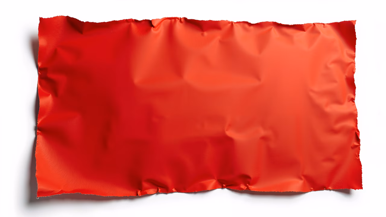 Vibrant red silk fabric against a white background, emphasizing luxury and elegance.