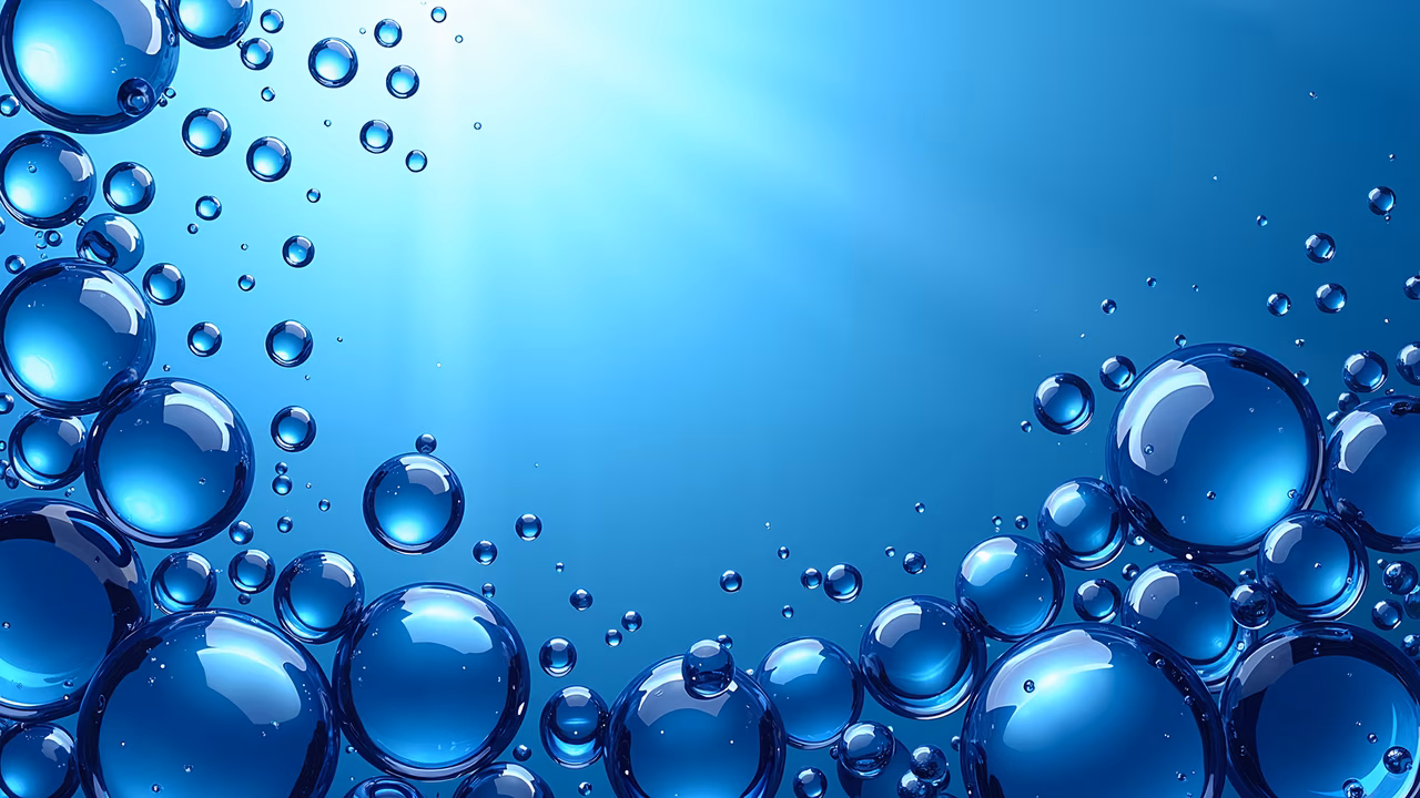 Vibrant blue bubbles on a gradient blue background, illustrating nature's beauty and movement.