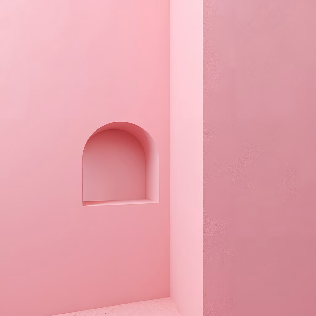 Minimalist pink archway recessed in a plain pink wall, creating depth and elegance.