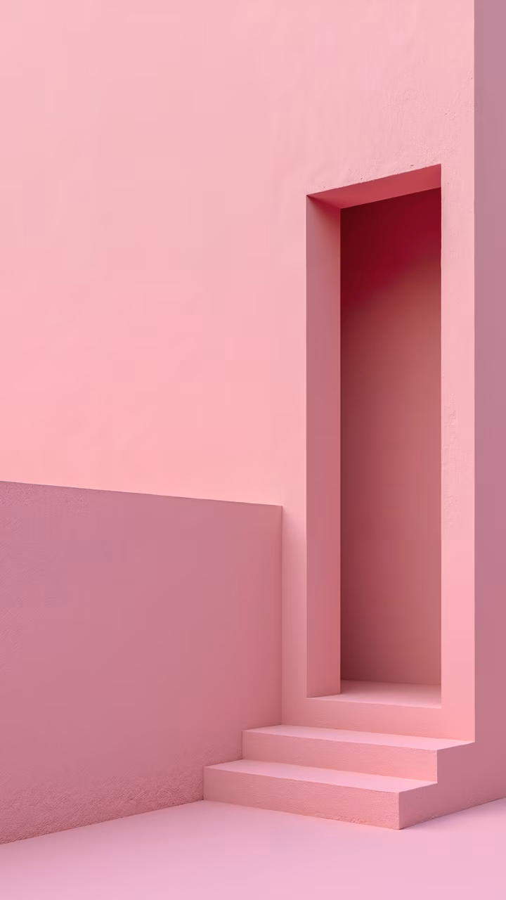 Minimalist pink doorway with steps and shadowed interior, serene and contemplative atmosphere.