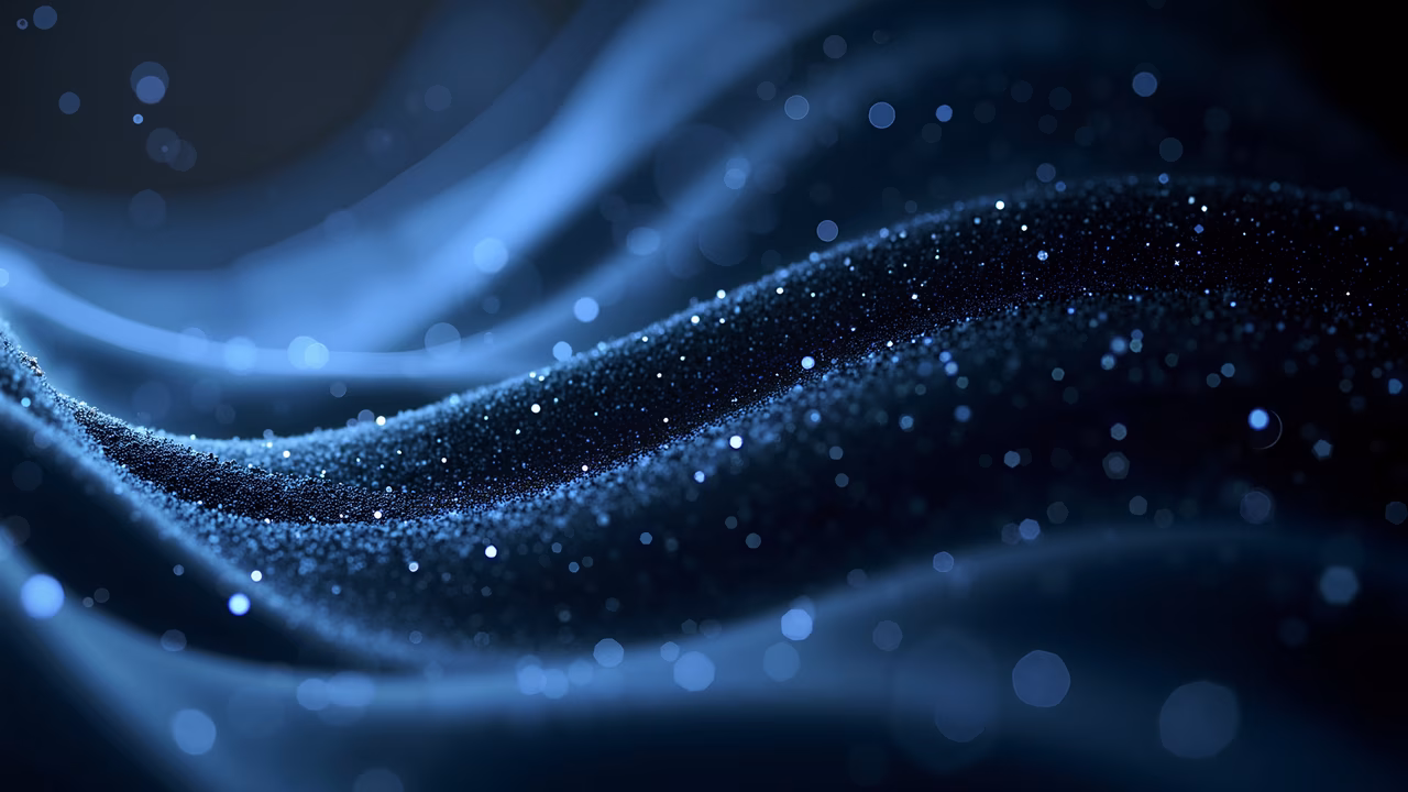Mesmerizing wave of sparkling blue particles against a dark background, creating a sense of depth and movement.