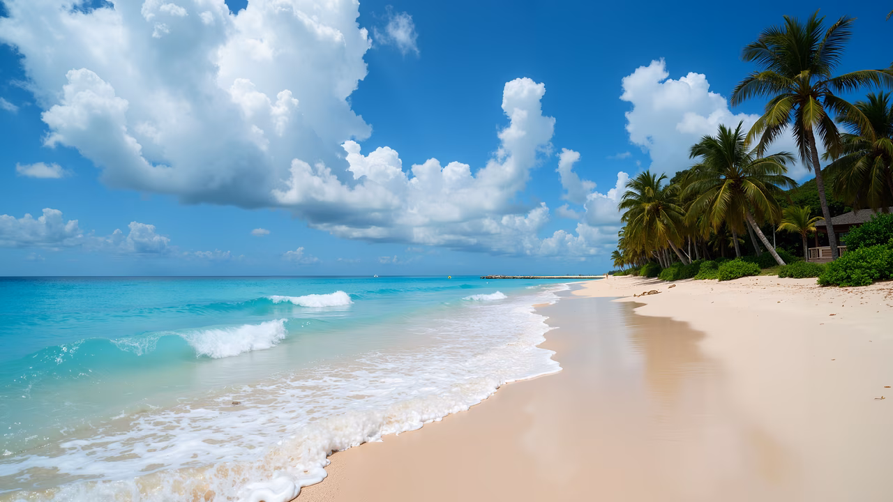 A peaceful tropical beach with sandy shores, turquoise waters, and fluffy clouds in the sky.