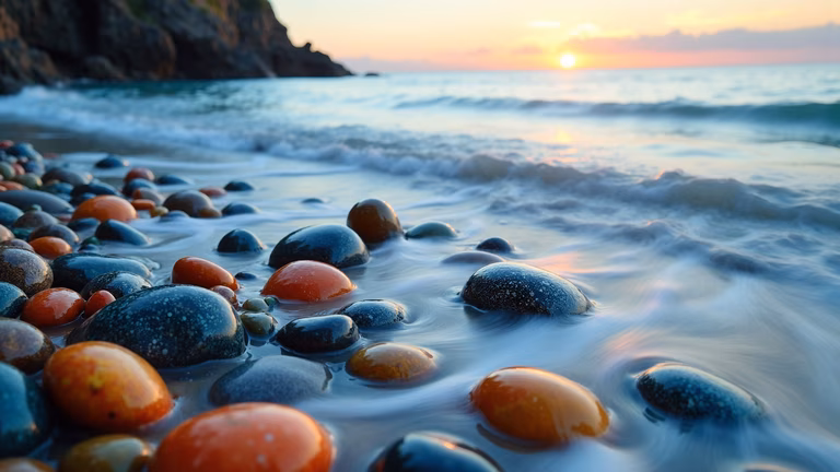 Vibrant sunset colors on beach pebbles, tranquil ocean waves, nature photography