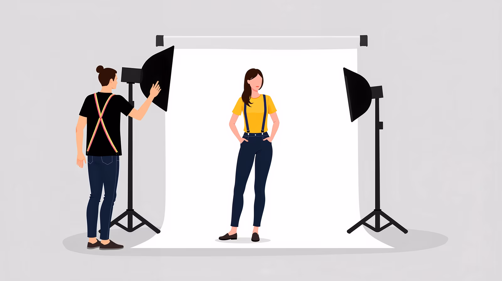 A photographer adjusts a softbox light while a model stands confidently during a photo shoot.