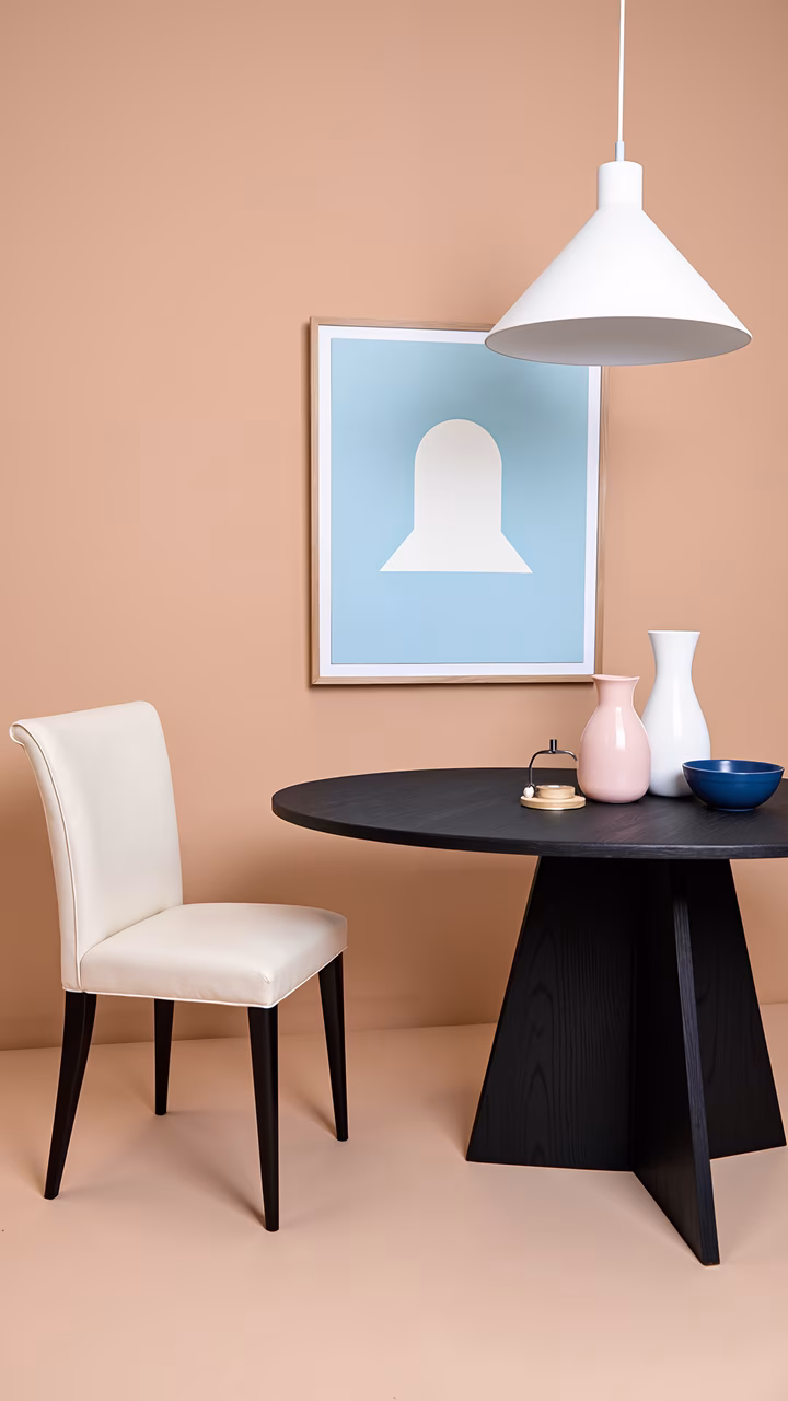 Modern minimalist dining setup with sleek furniture and soft colors.