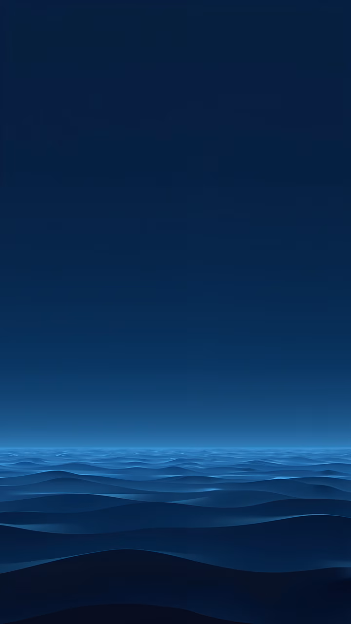 Minimalist ocean waves under a deep blue sky, evoking tranquility and introspection.