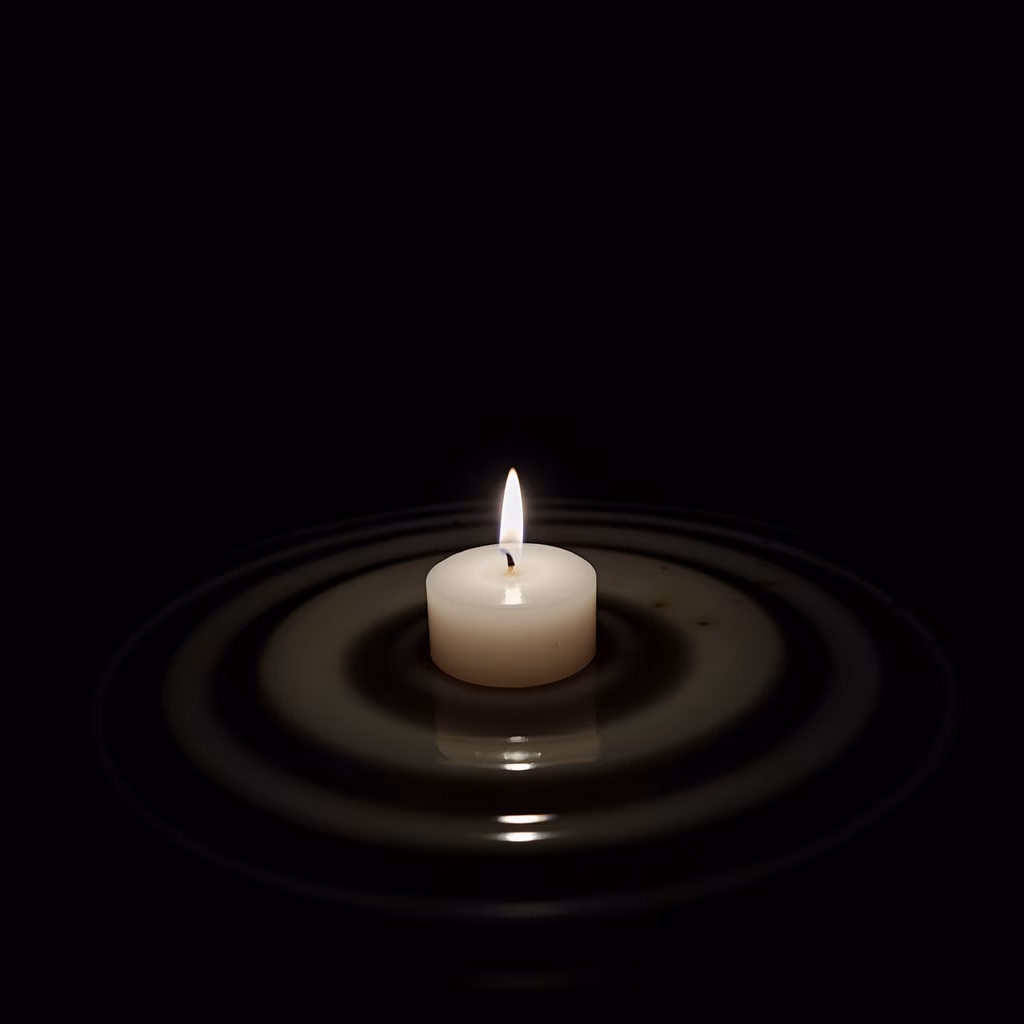 A solitary candle illuminates a dark scene, reflecting on a rippling surface.