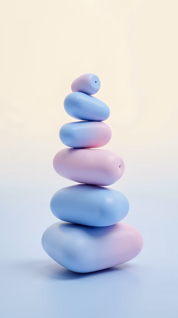 A serene stack of pastel pebbles in a balanced composition.