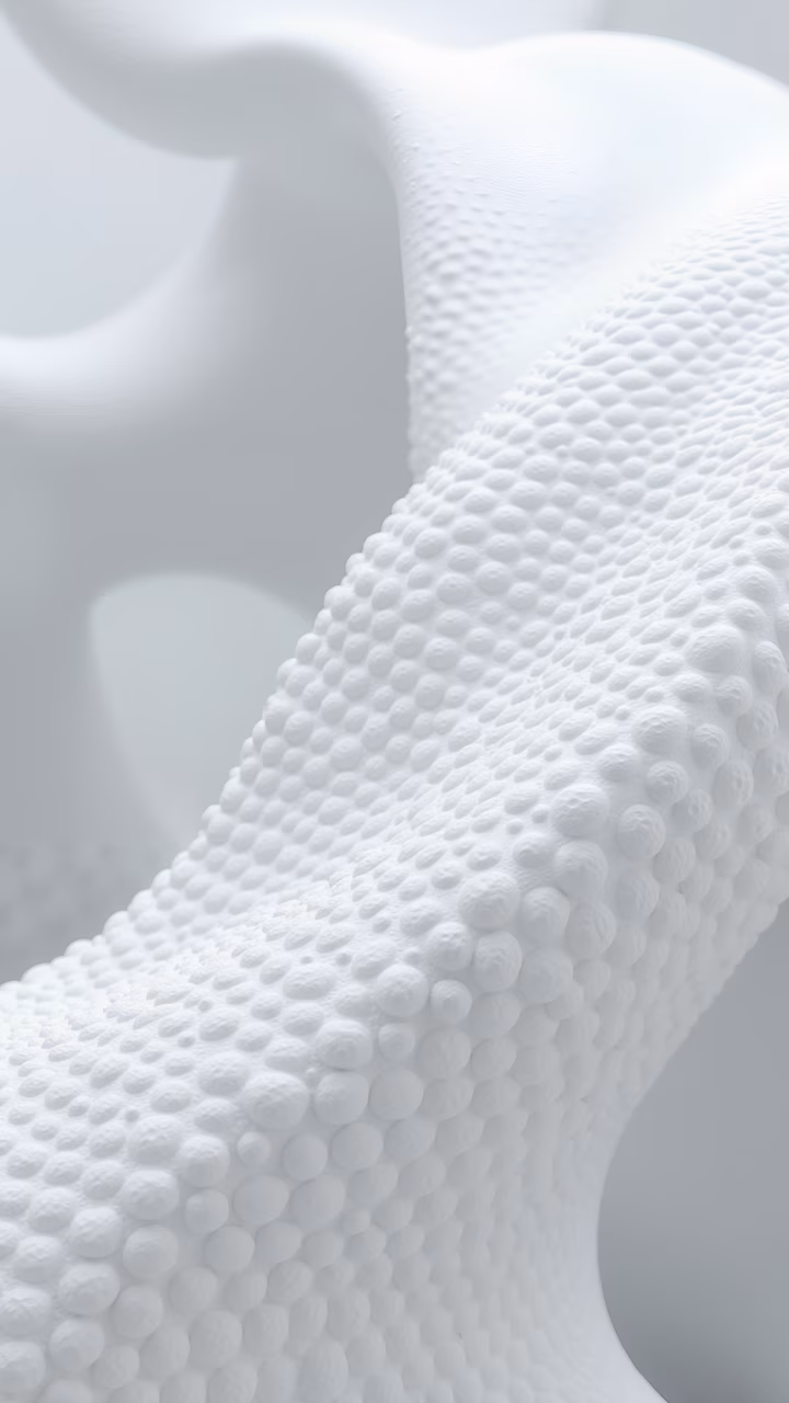 Monochrome abstract sculpture with textured surface, minimalist design, serene atmosphere.