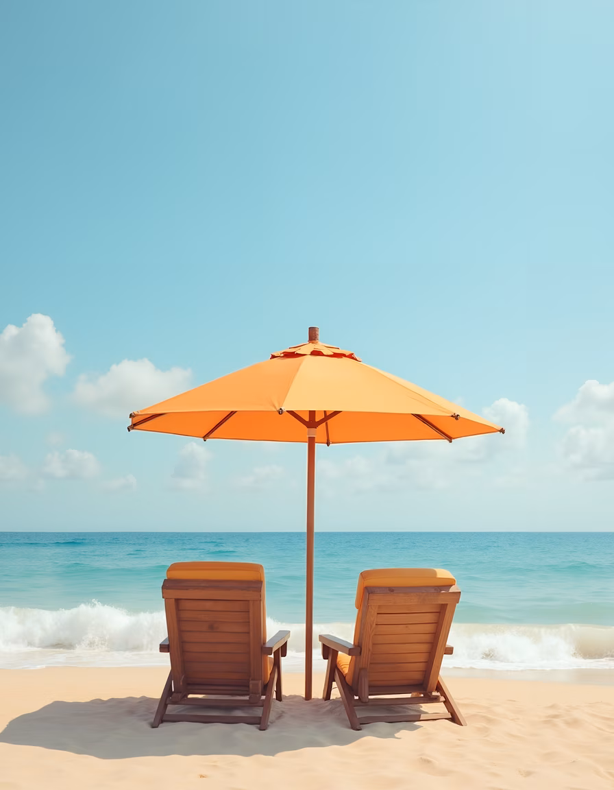 Relaxing beach chairs under an orange umbrella by the sea.