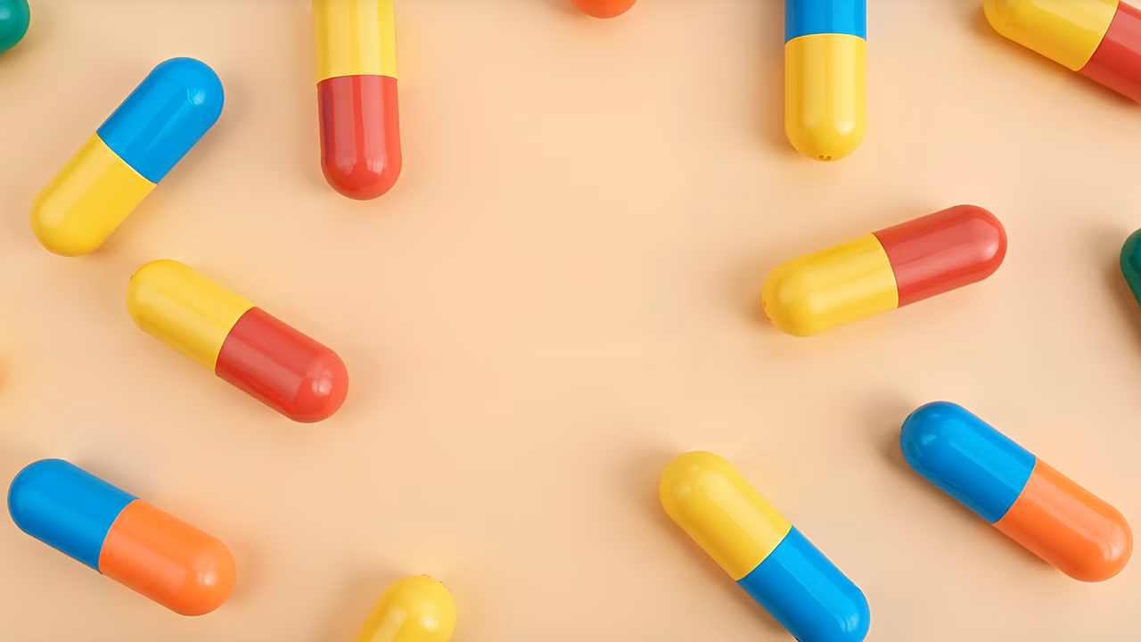 Vibrant capsules on a beige background, product photography.