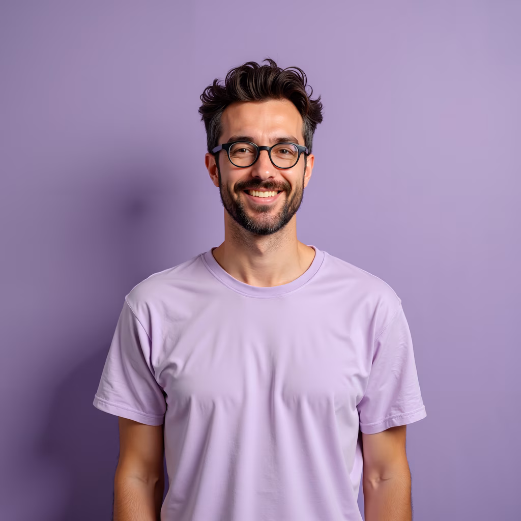 Friendly portrait of a man in a lavender shirt against a purple background.
