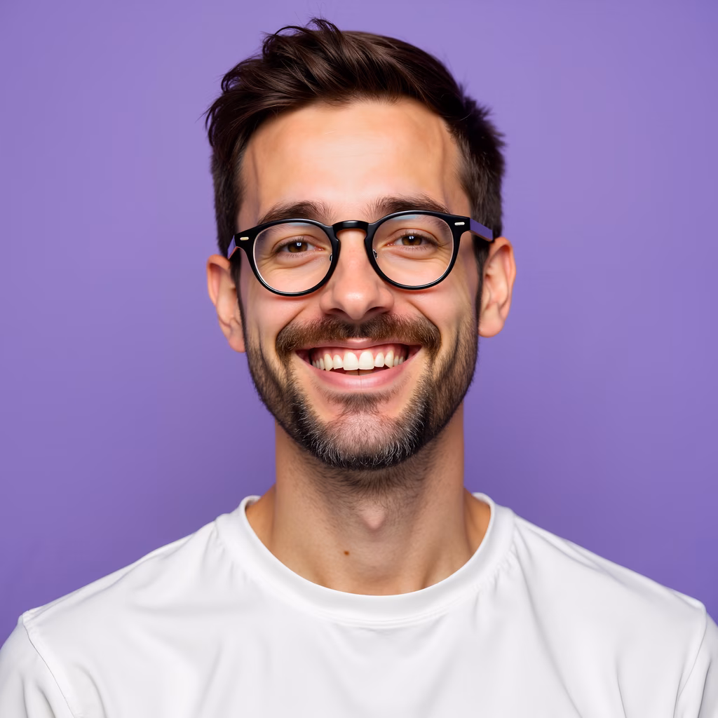 Close-up portrait of a smiling man with glasses against a purple background.