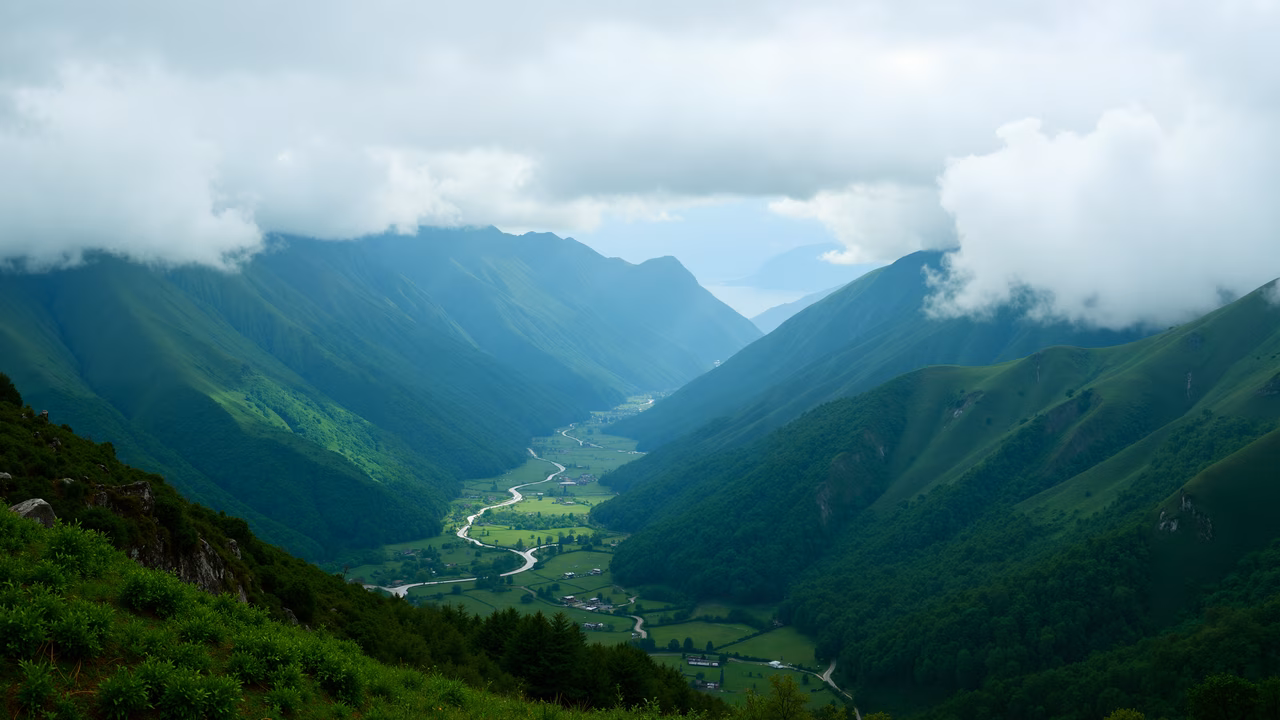 A tranquil mountain valley with lush greenery and a winding river.