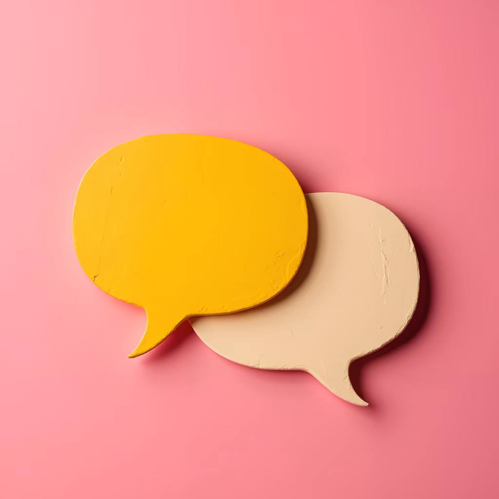 Vibrant yellow and beige speech bubbles on a pink background, symbolizing conversation and interaction.