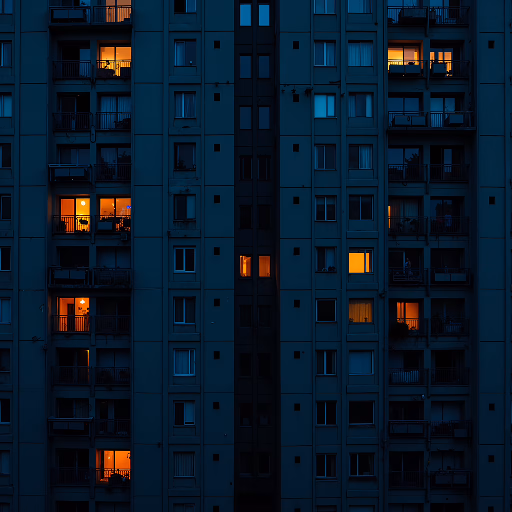 Twilight urban landscape with glowing windows and contrasting colors.