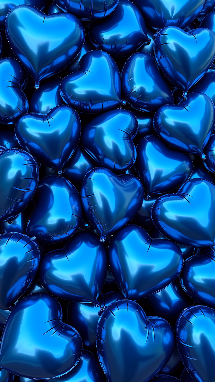 Glossy blue heart balloons on a black background, celebrating Valentine's Day.