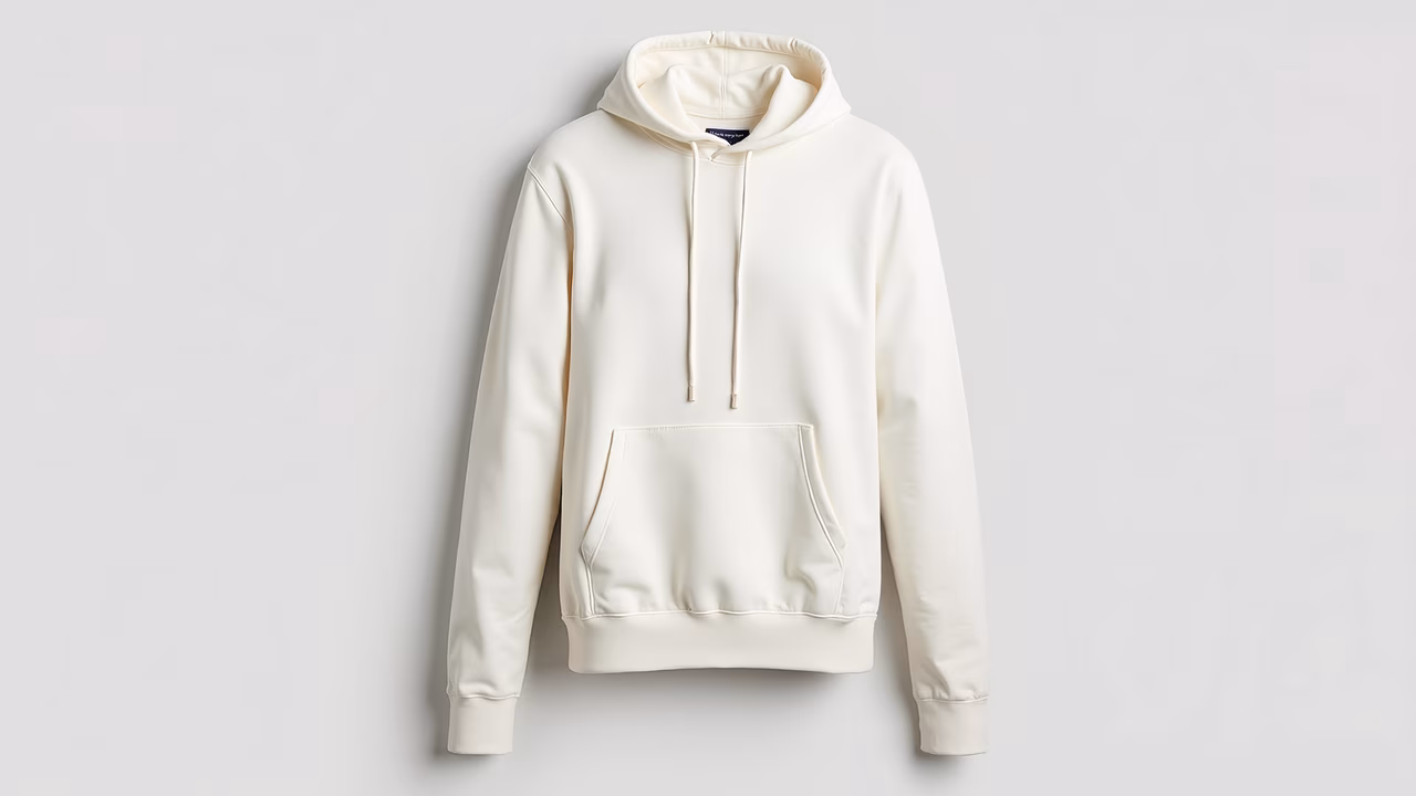 Cream hoodie on a white background, minimalist fashion.
