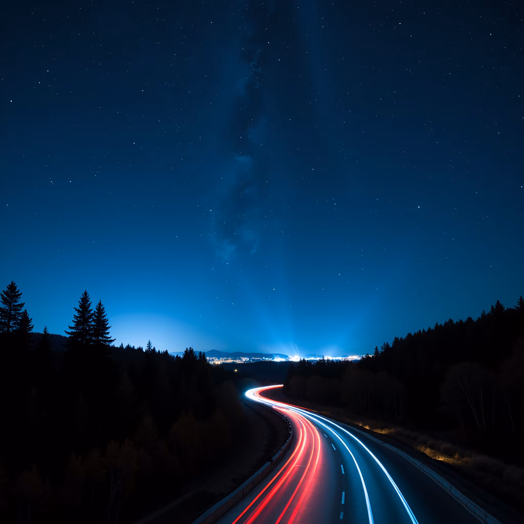 Night road lights create a mesmerizing trail of colors against a starlit sky.