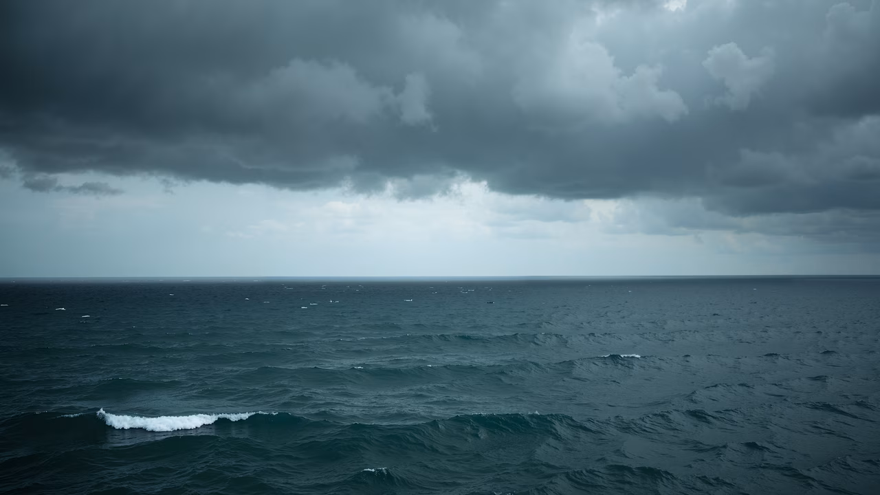 Dark clouds loom over the tranquil ocean, creating a sense of impending drama.