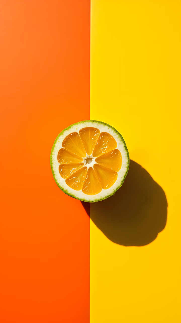 Vibrant orange slice on contrasting orange-yellow background