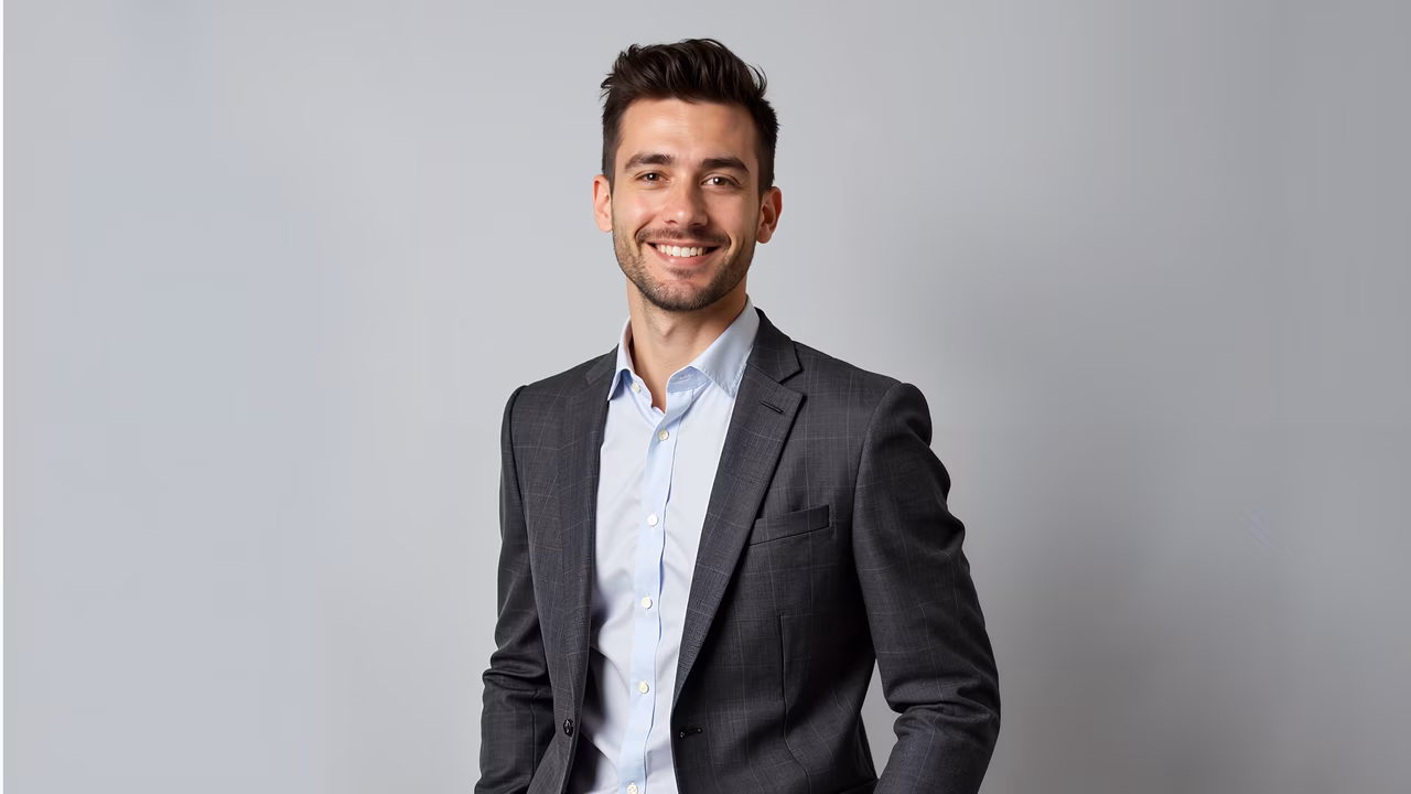 Confident professional portrait with soft lighting and neutral background.
