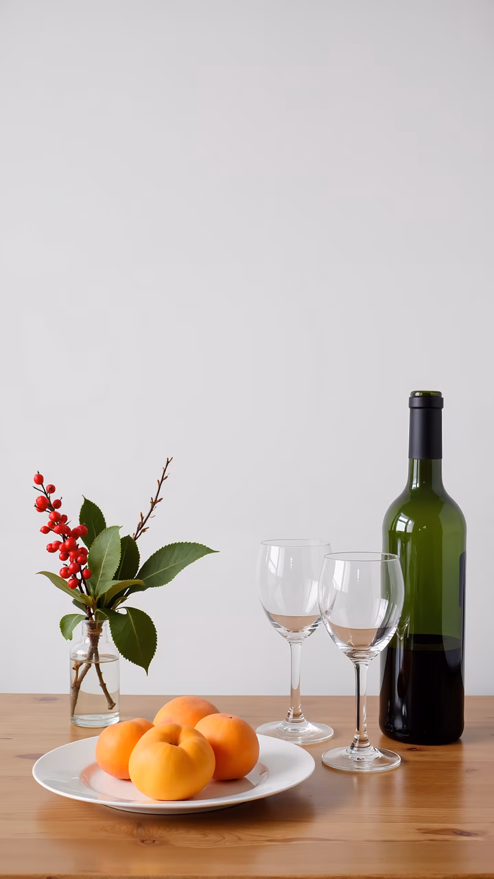 A tranquil still life featuring apricots, wine, and natural decor.