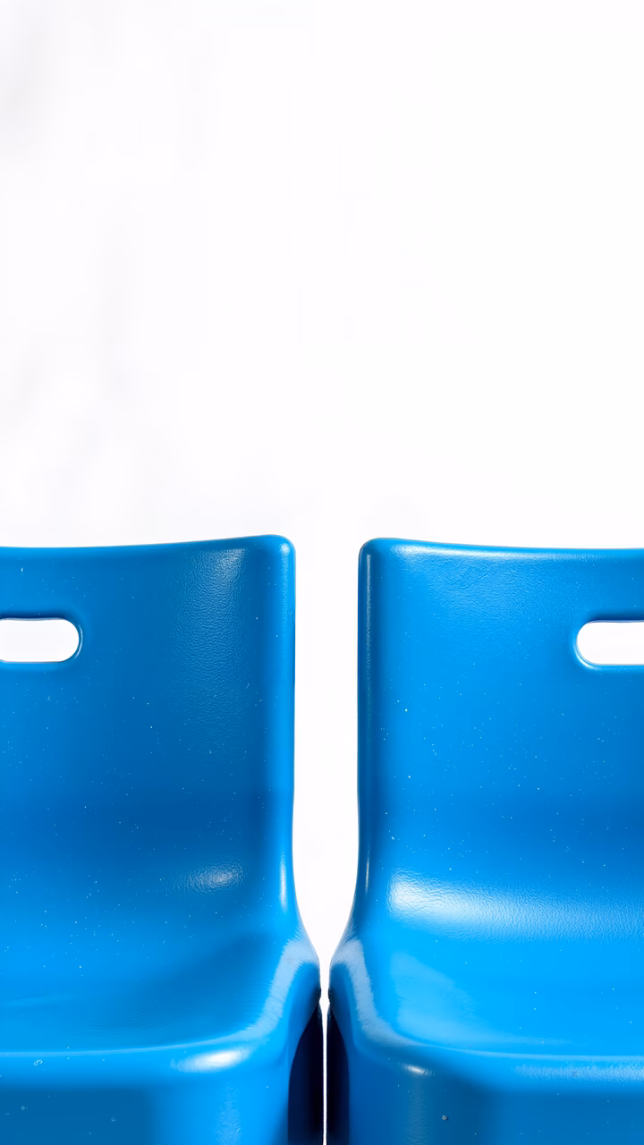 Minimalist blue chairs against a white backdrop