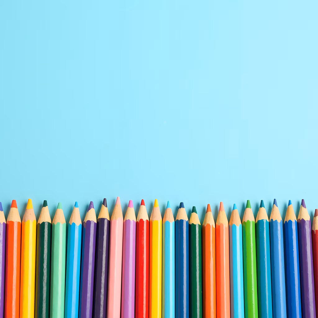 A row of colorful pencils against a blue backdrop, symbolizing creativity and artistry.