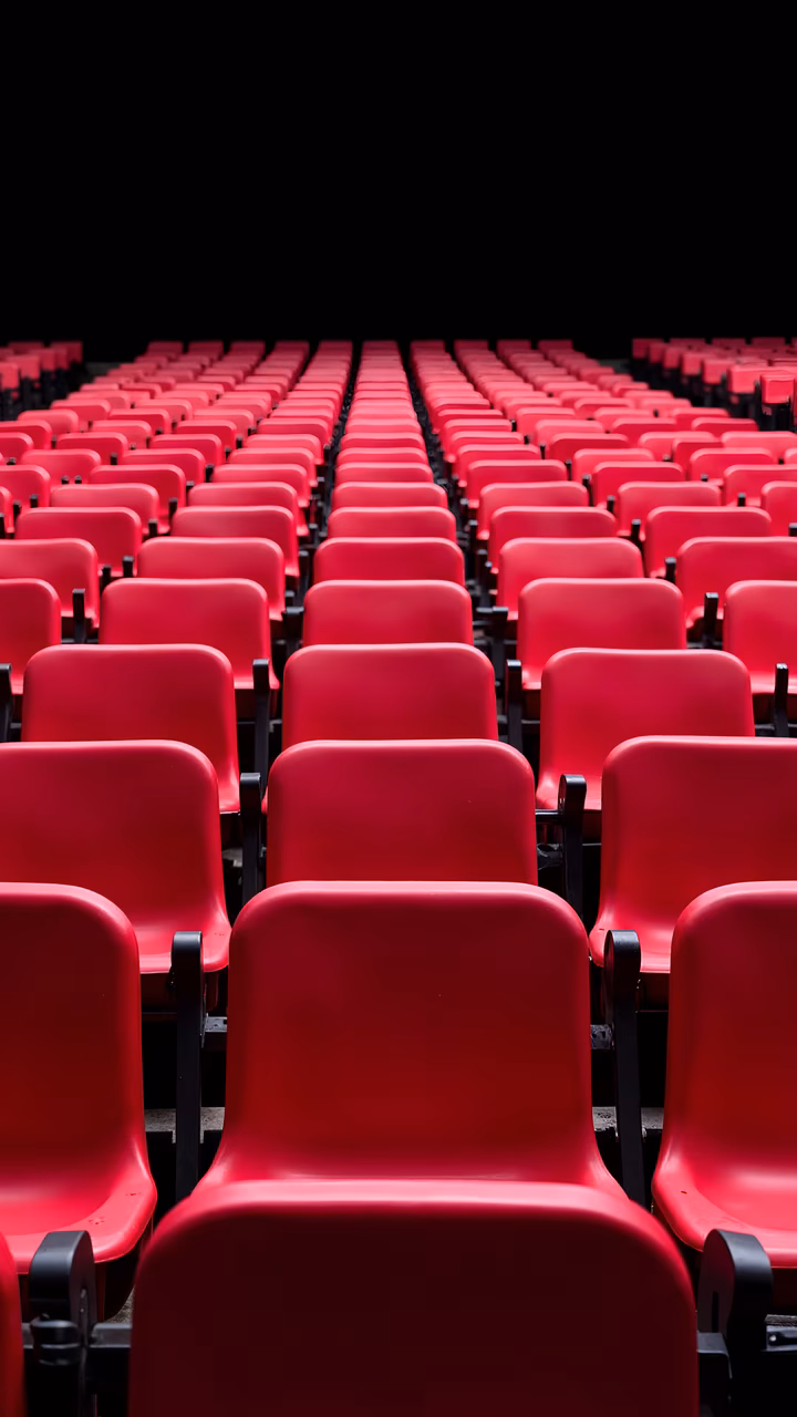 Symmetrical red seats in a minimalist setting.