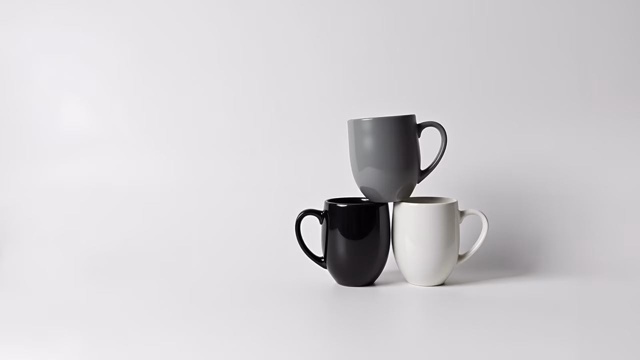 Minimalist still life featuring three contrasting cups on a white background.