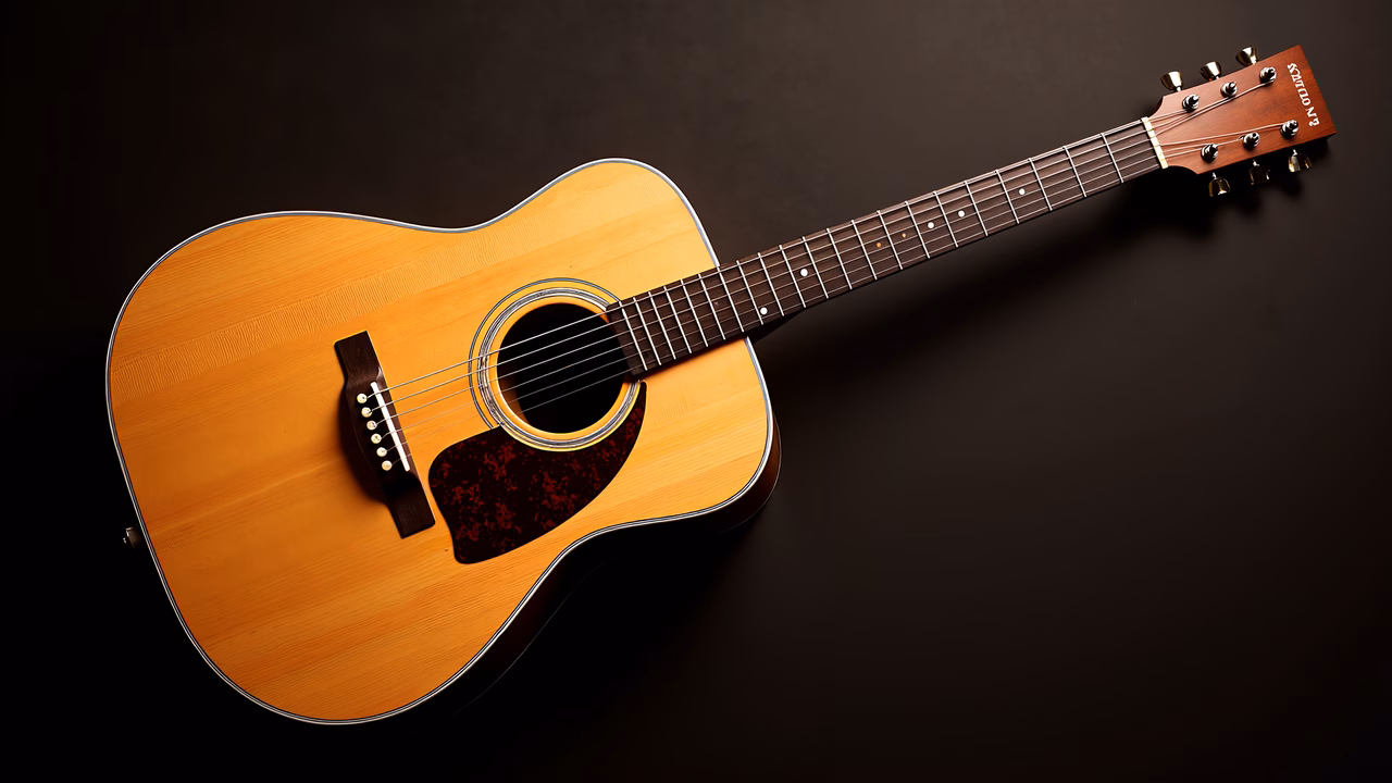 Close-up of a classic acoustic guitar against a dark background, highlighting its natural wood finish and glossy black pickguard.