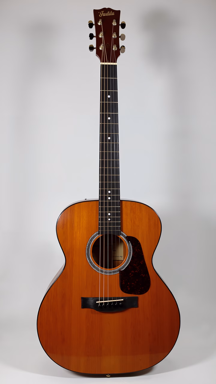 A close-up of a wooden acoustic guitar with a glossy finish and dark fretboard against a white backdrop.