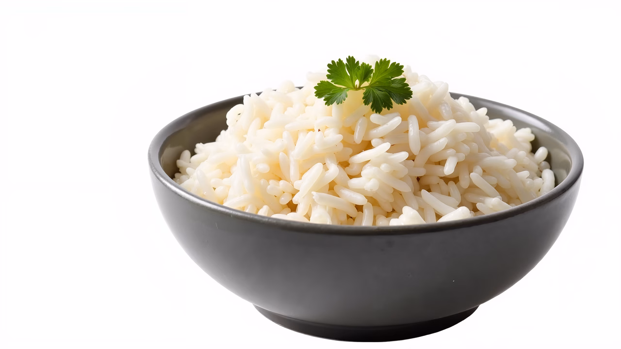 Close-up of a bowl of fluffy white rice garnished with cilantro, emphasizing freshness and abundance.