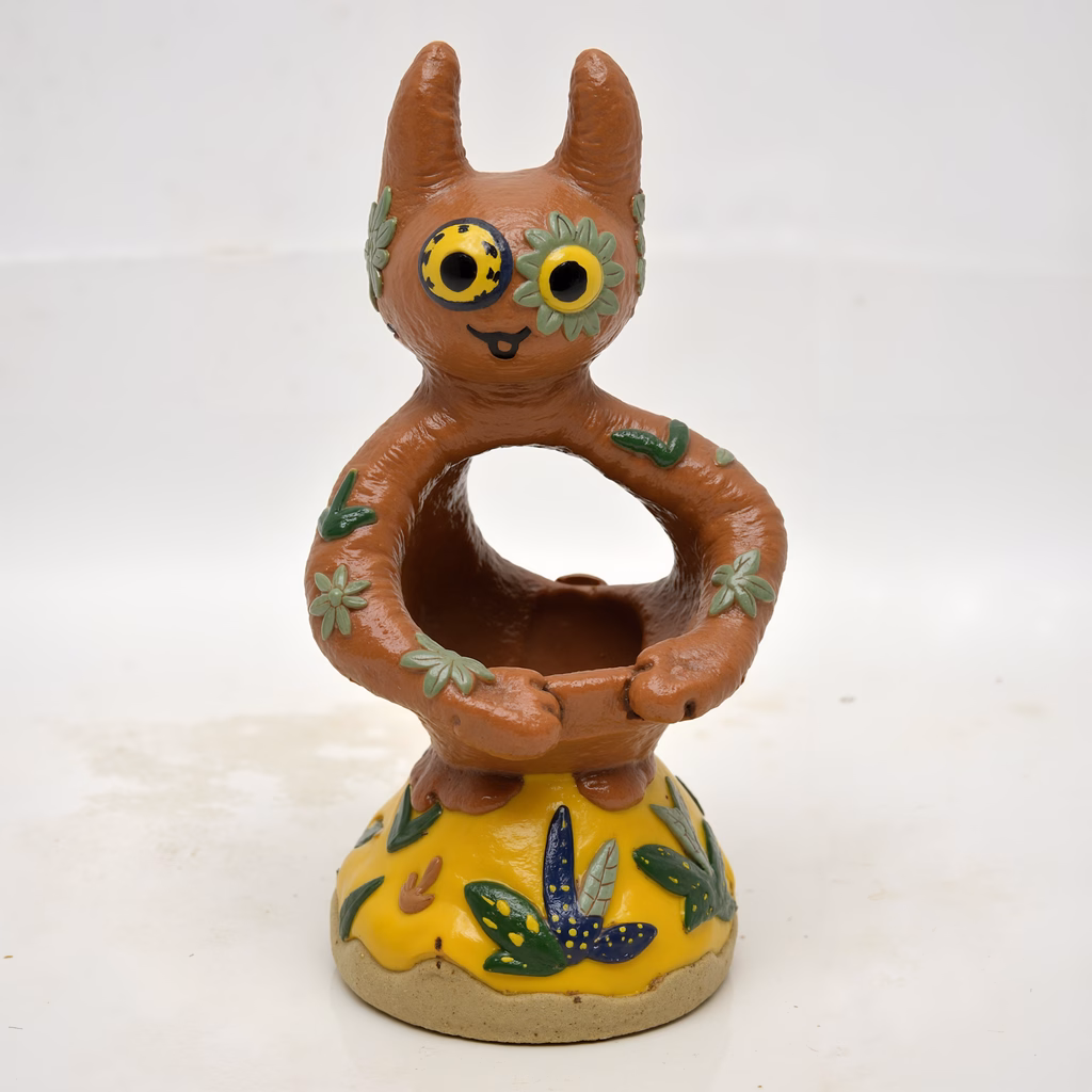 Whimsical cartoon owl statue with vibrant floral decorations.