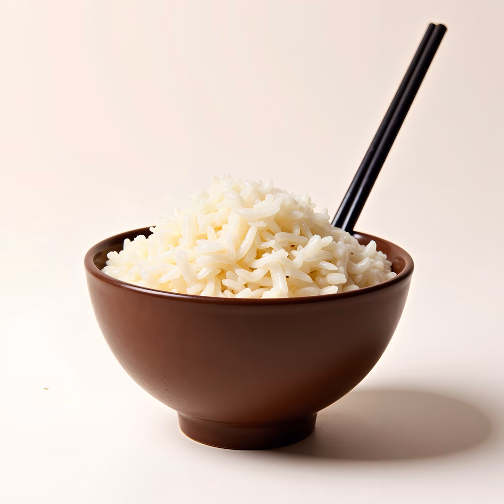 Close-up of steaming white rice in a brown bowl with black chopsticks.