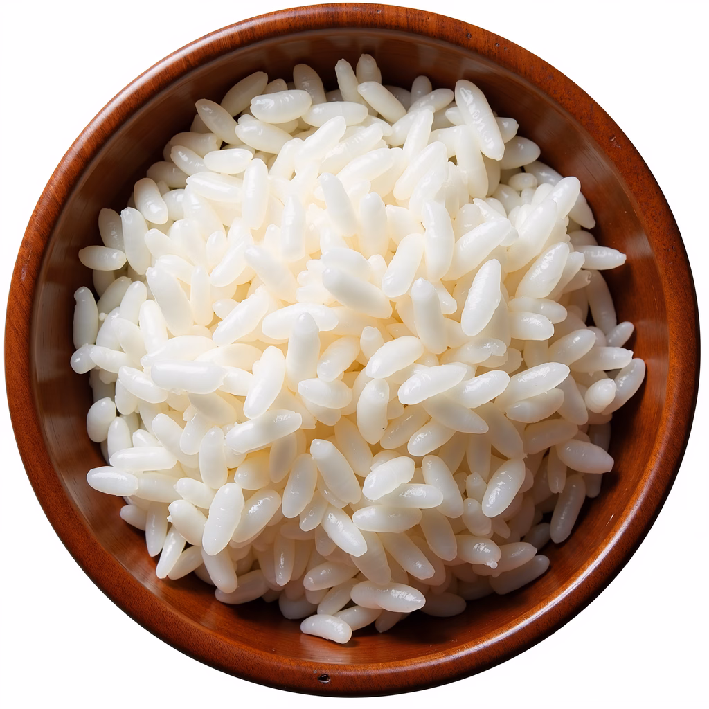Close-up of white rice in a wooden bowl, emphasizing texture and simplicity.