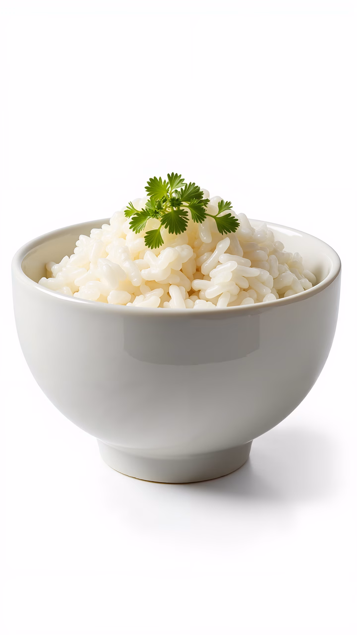A close-up of a bowl of white rice with cilantro garnish against a white background.