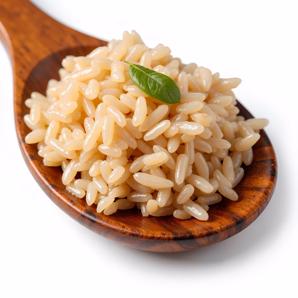 Close-up of cooked rice on a wooden spoon, showcasing its glossy texture and natural beige hue.
