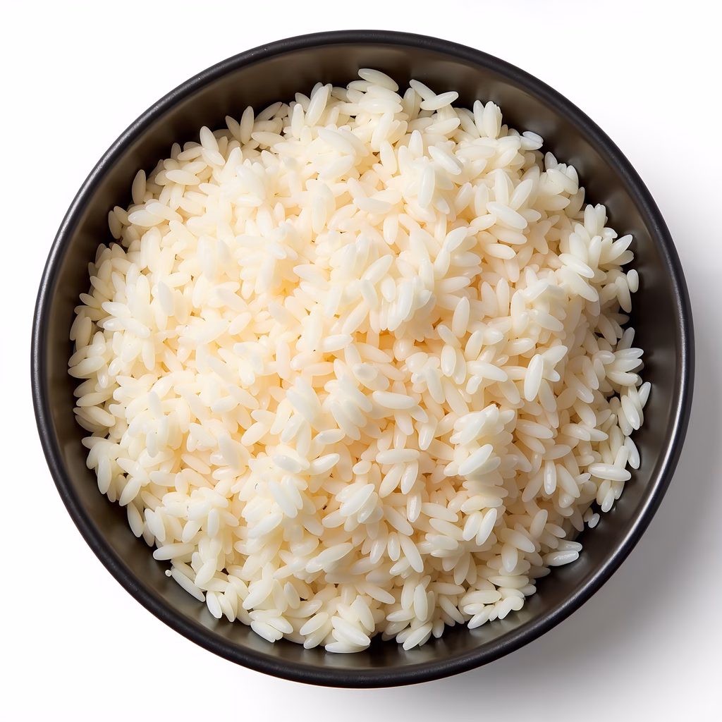 Close-up of white rice in a dark bowl on a white background.