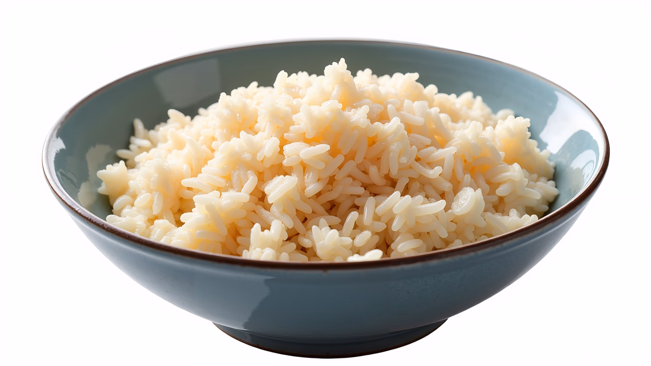 Close-up of freshly cooked rice in a simple blue bowl.