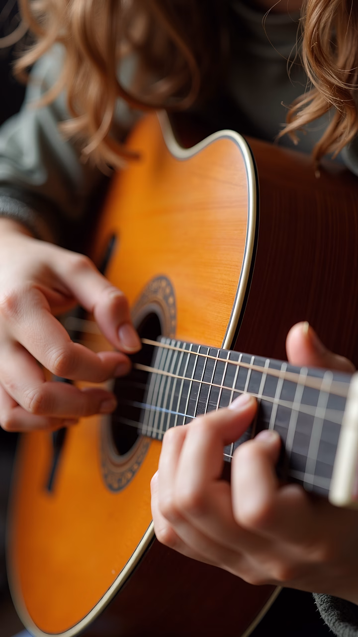 Close-up of hands strumming an acoustic guitar, evoking a sense of musical passion and tranquility.
