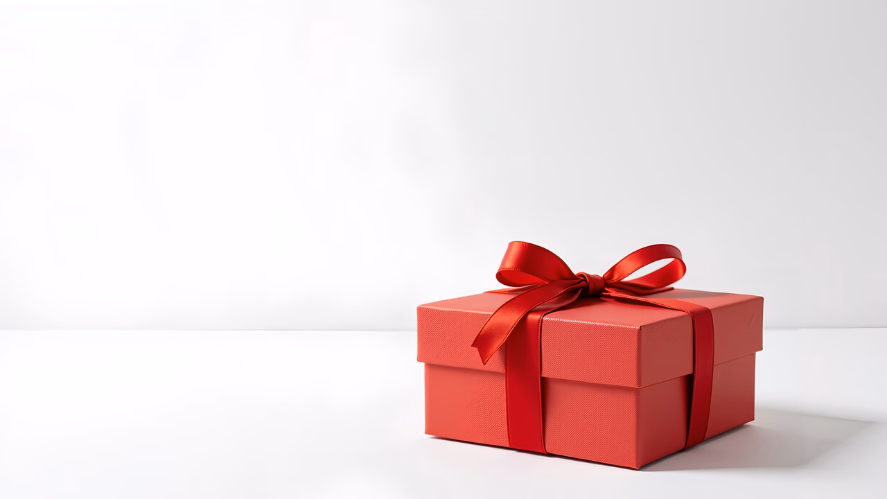 A beautifully wrapped red gift box on a white background.