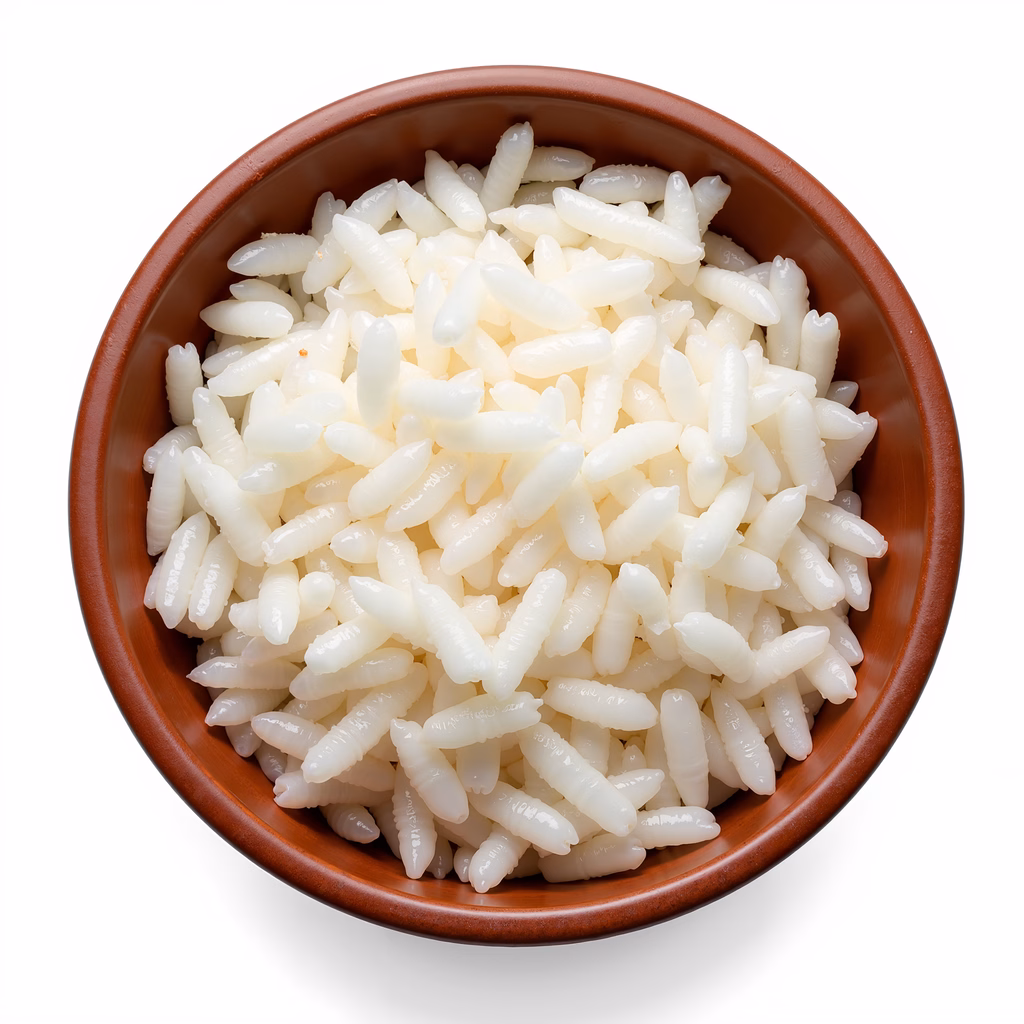 Close-up of white rice in a rustic bowl, emphasizing texture and simplicity.