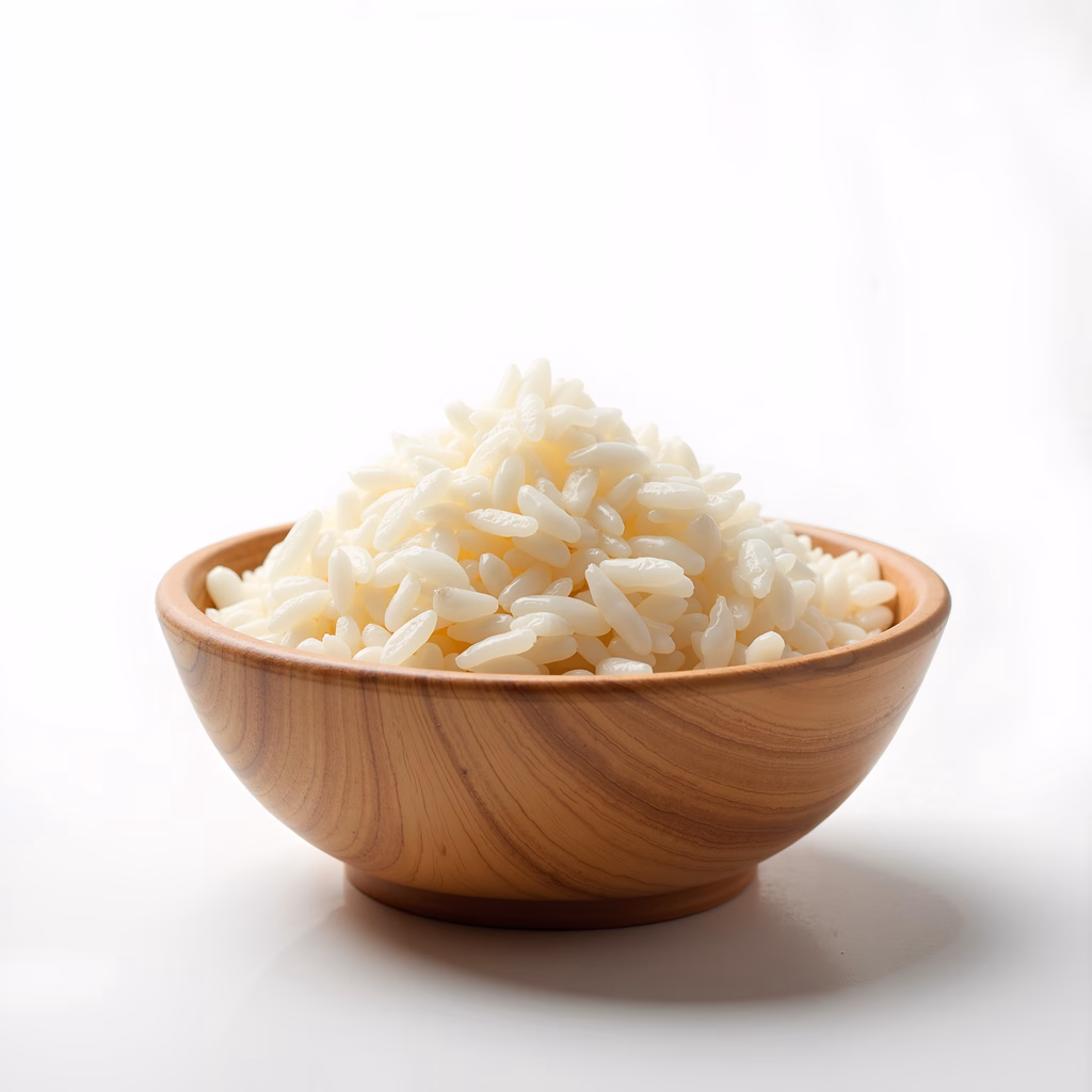 Close-up of white rice in a wooden bowl on a white background.