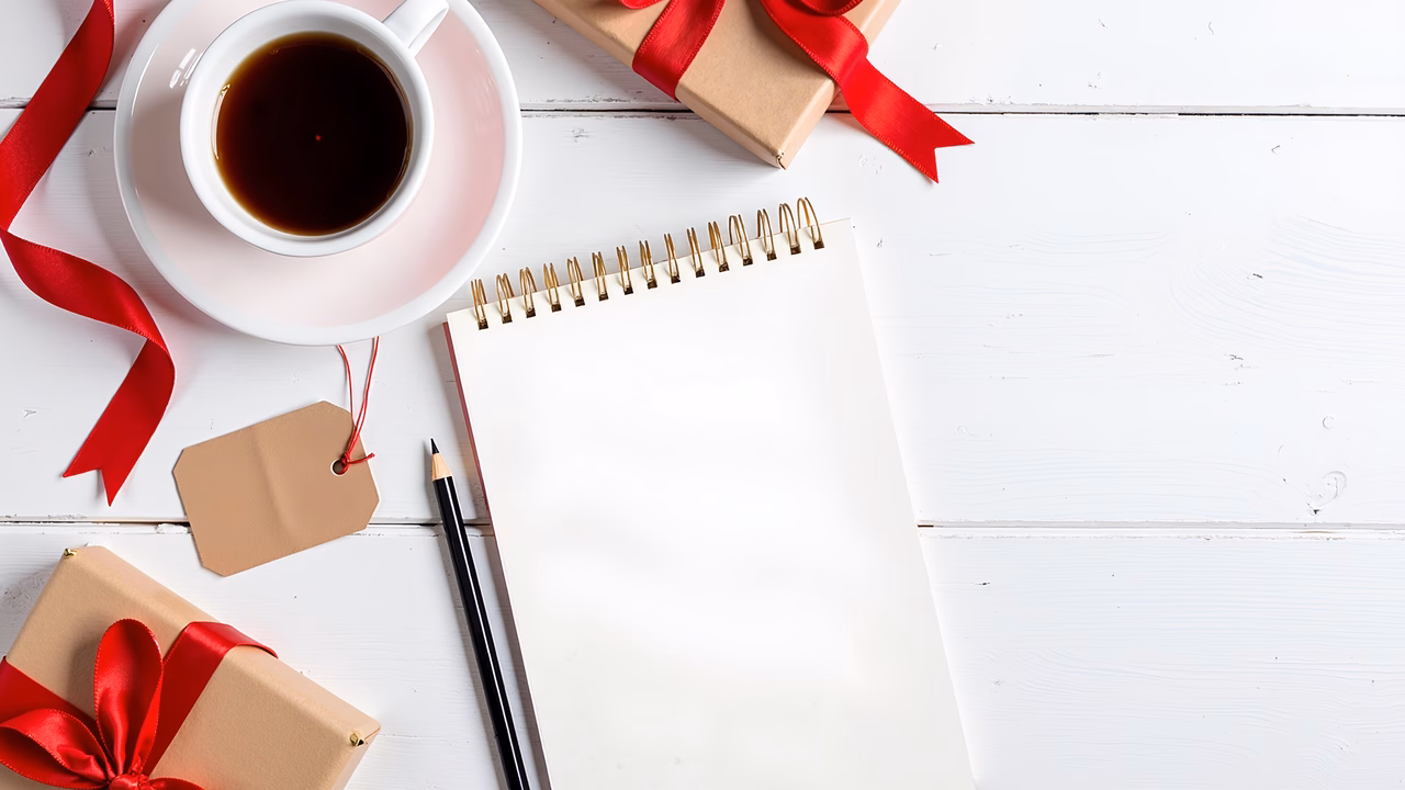 Warm holiday preparation with gifts and coffee on a white wooden table.